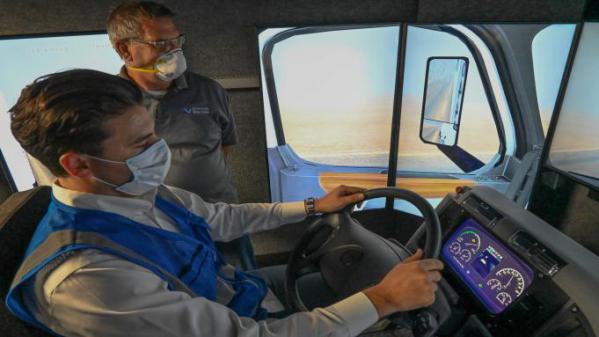 SBVC professor Berchman “Kenny” Melancon observes as Enrique Allen Mar of Advanced Training Systems demonstrates a commercial truck driving simulator the college is acquiring as part of its expanded clean vehicle technology curriculum (photo credit: LaVar Godoy)