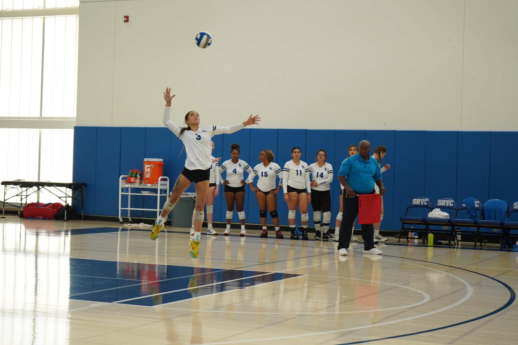 A volleyball player preparing to return the ball to the other side