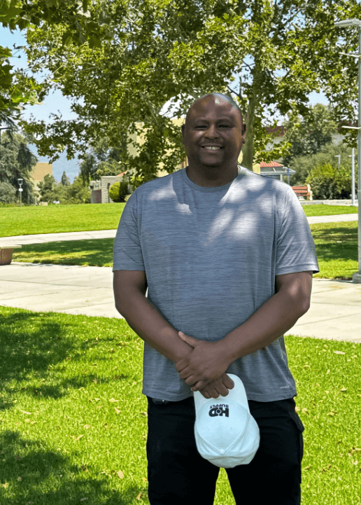 Ray Avie Jr. poses with arms crossed