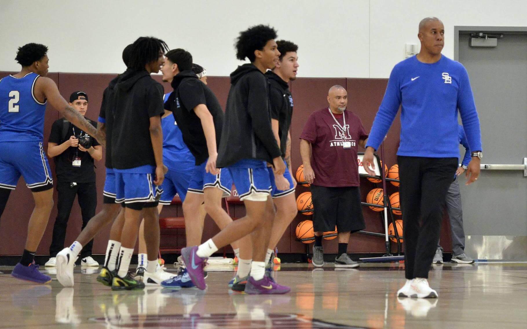 Coach Quincy Brewer with students on the court.
