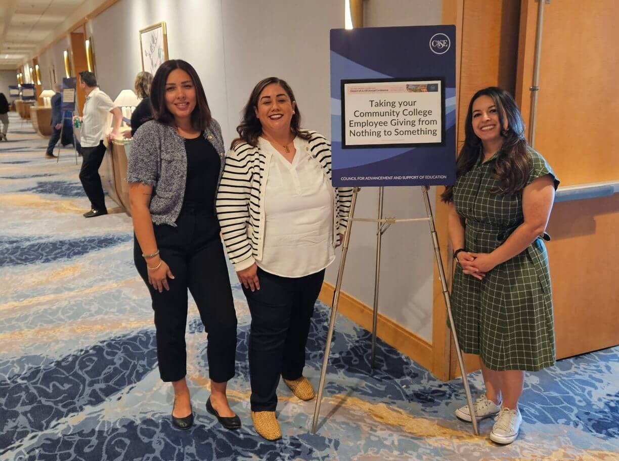 Three SBVC Foundation staff members pose beside a CASE conference presentation sign highlighting a session on community college employee giving and philanthropic engagement.